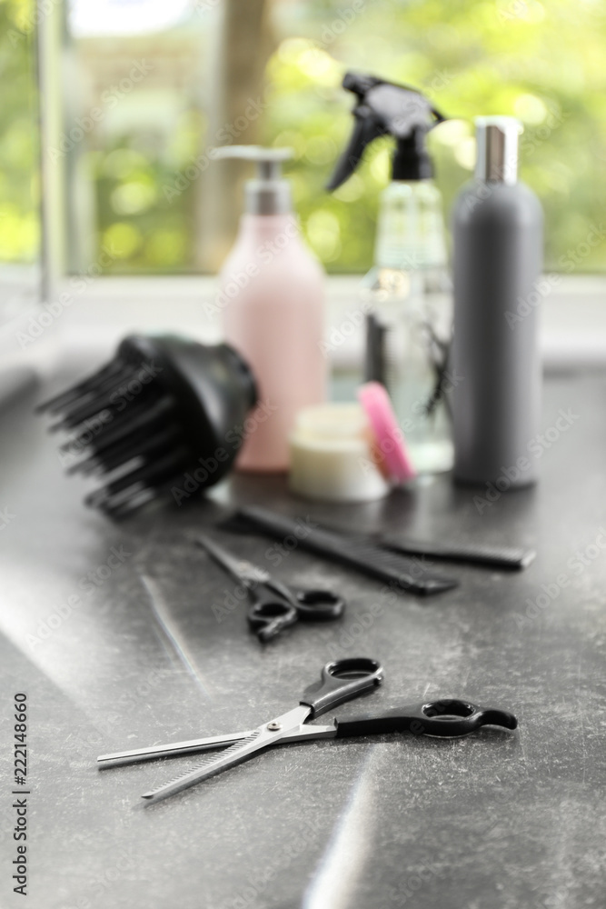 Scissors with hairdressers supplies on table