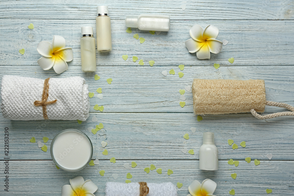 Beautiful spa composition with cosmetics on light wooden table