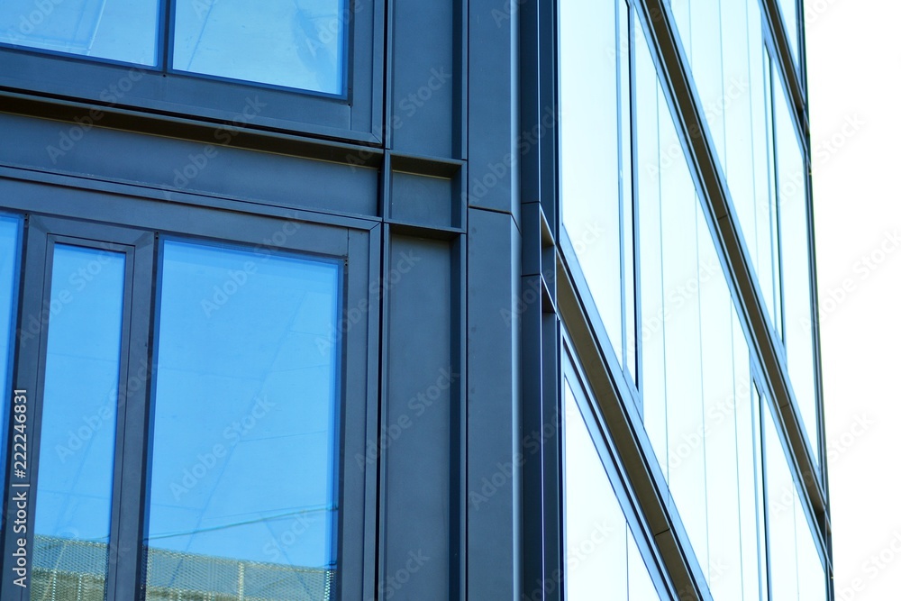 Abstract fragment of contemporary architecture, walls made of glass and concrete. Glass curtain wall