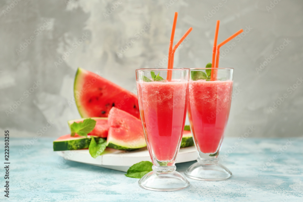 Glasses with fresh watermelon smoothie on light table