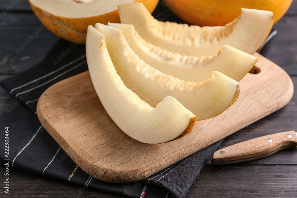 Slices of ripe melon on wooden board