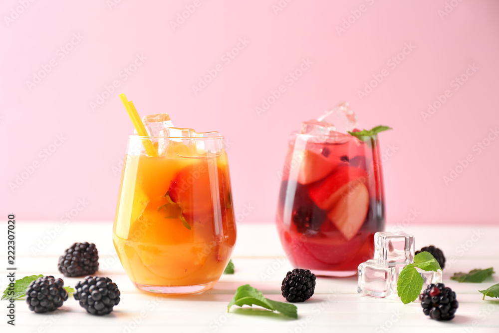 Fresh summer cocktails in glasses on white wooden table