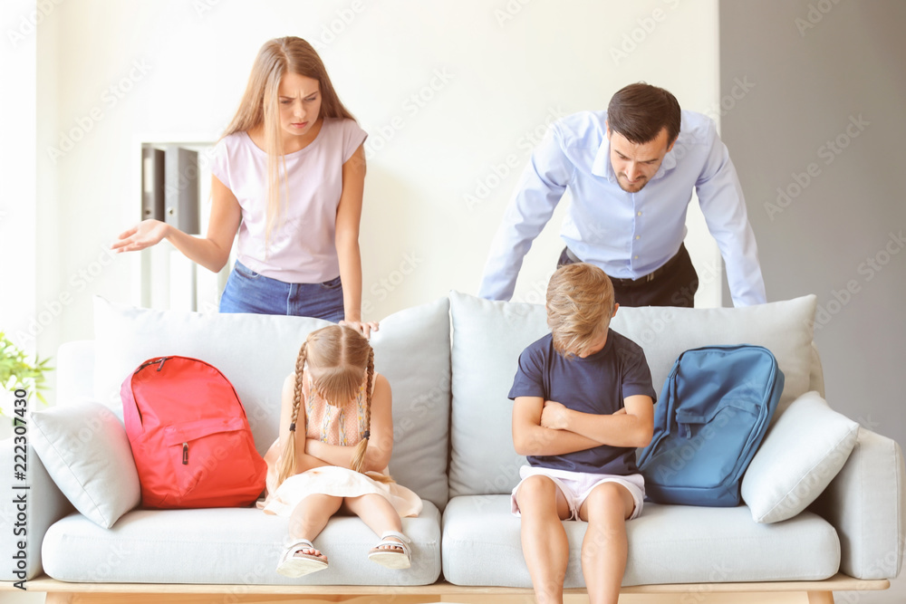 Displeased parents and their children after meeting with headmaster at school