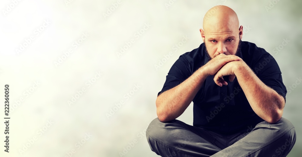 Portrait of young man in black shirt on street background