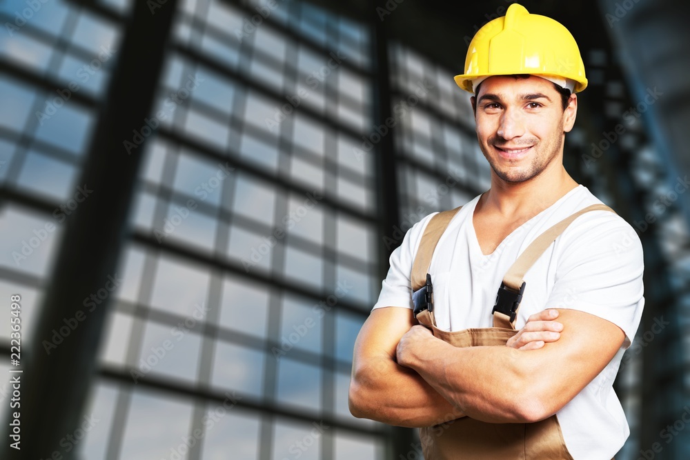 Portrait of happy young foreman with hard hat