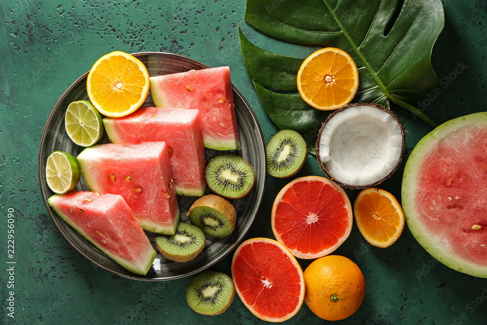 Flat lay composition with various delicious fruits on color background