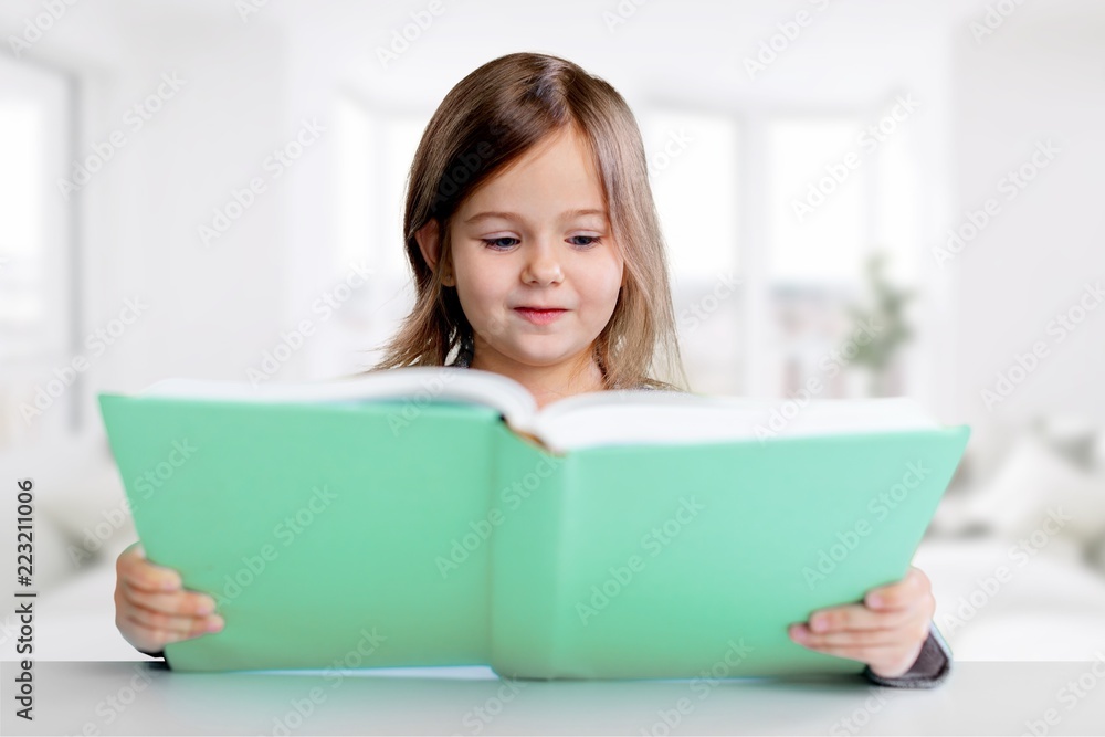 Portrait of young cute girl with book