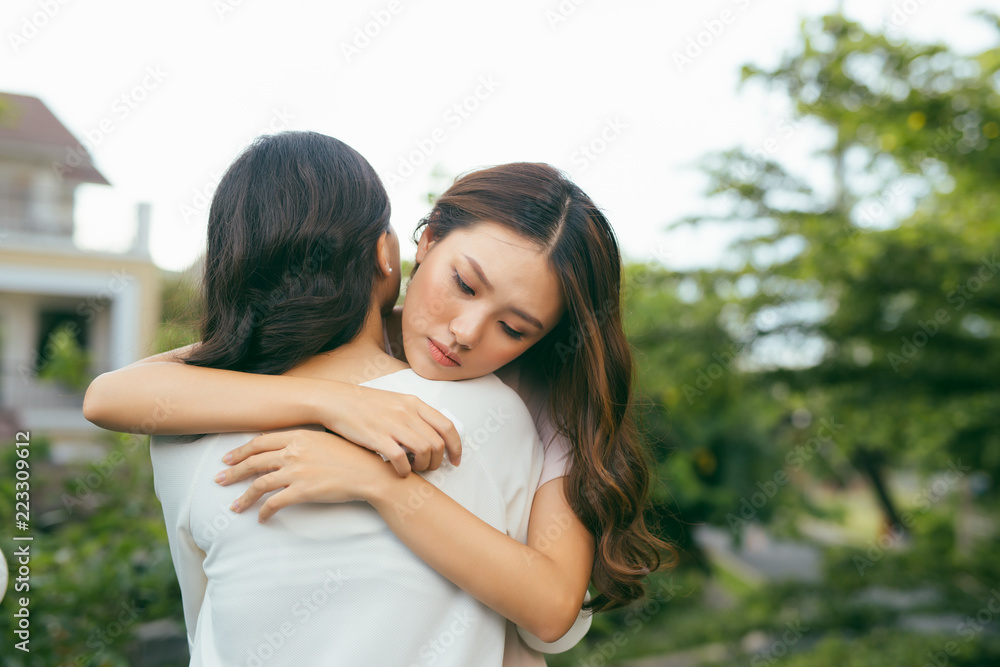 两个女人的画像。悲伤不快乐的年轻女人被她的朋友安慰。友谊有助于支持一个