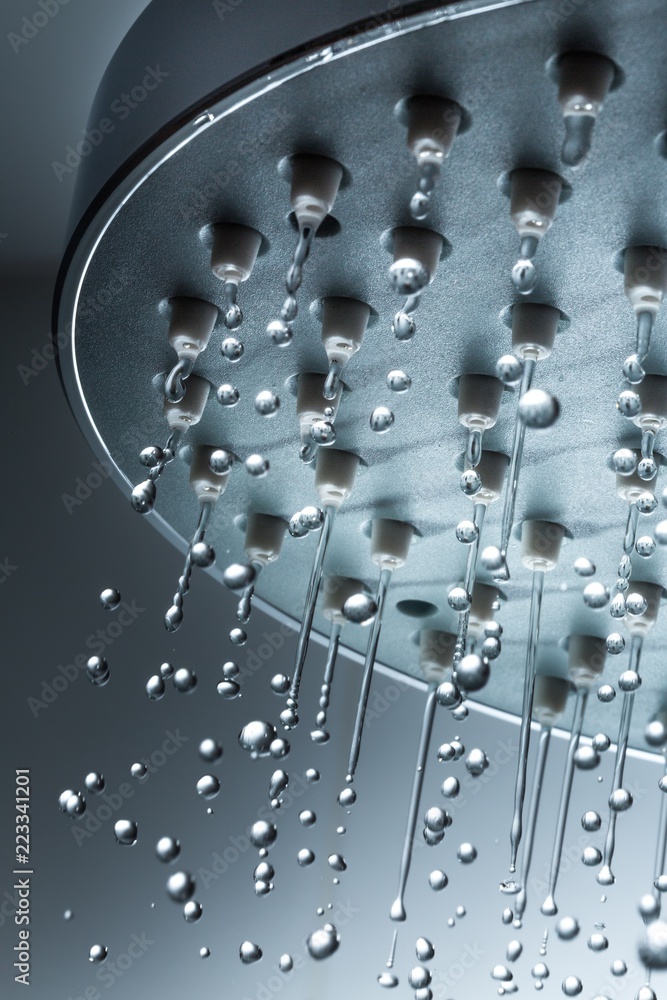 Shower Head with Water Stream on Grey Background