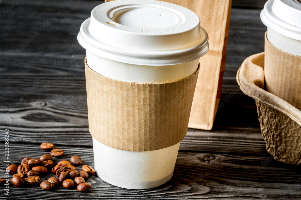 coffee cup to go at wooden background