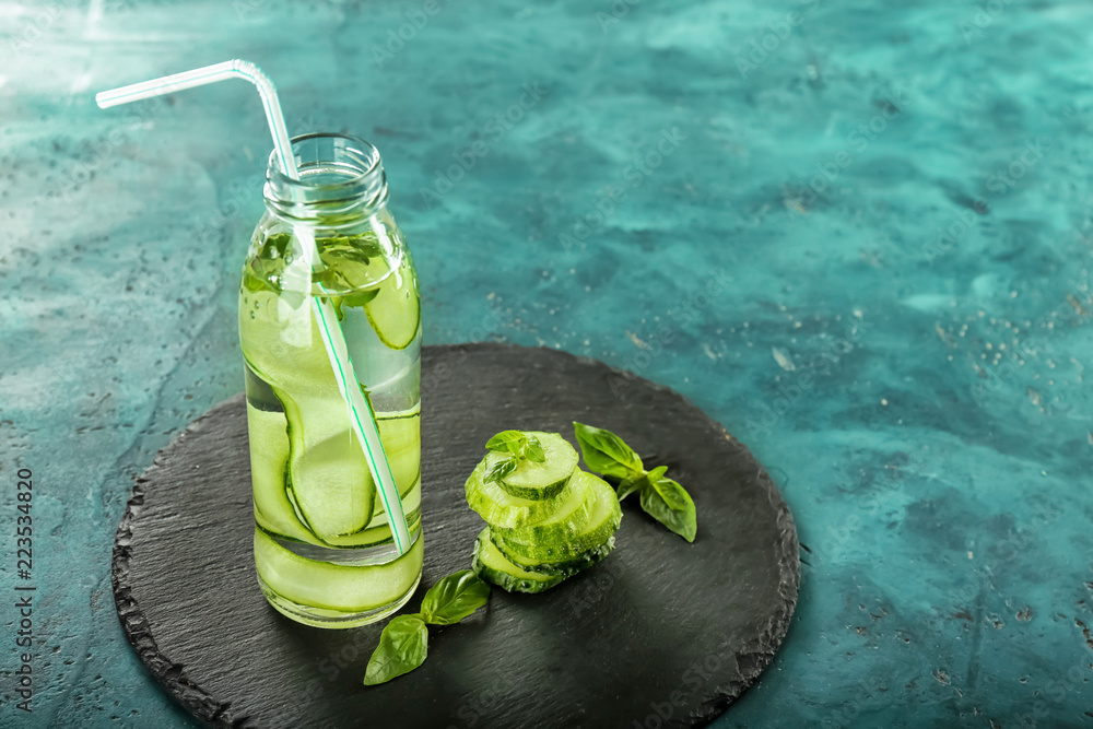 Bottle of cucumber infused water on table