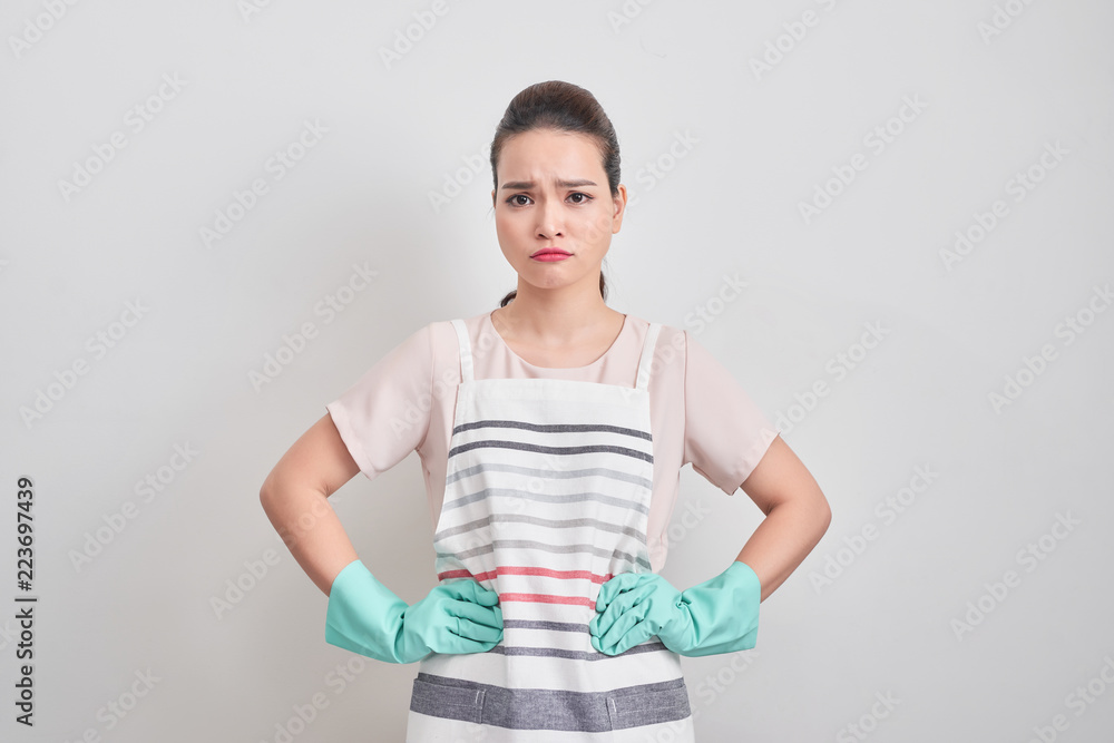 Tired young woman standing blue gloves isolated on white background, Housework concept