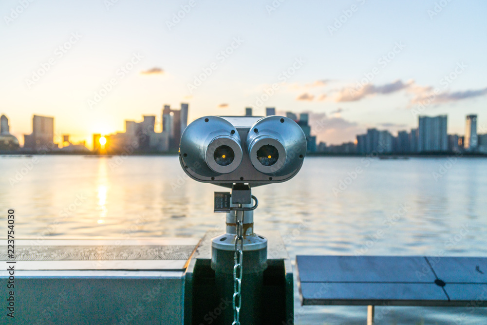 telescope with city skyline in hangzhou china