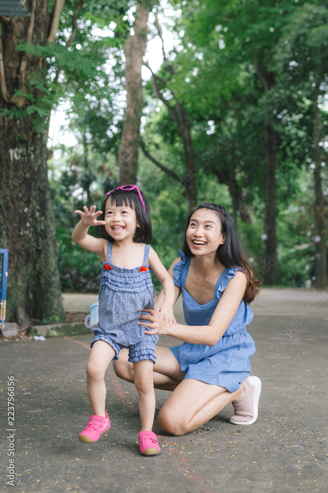 小女孩拥抱母亲的肖像，带着自然和阳光，家庭概念