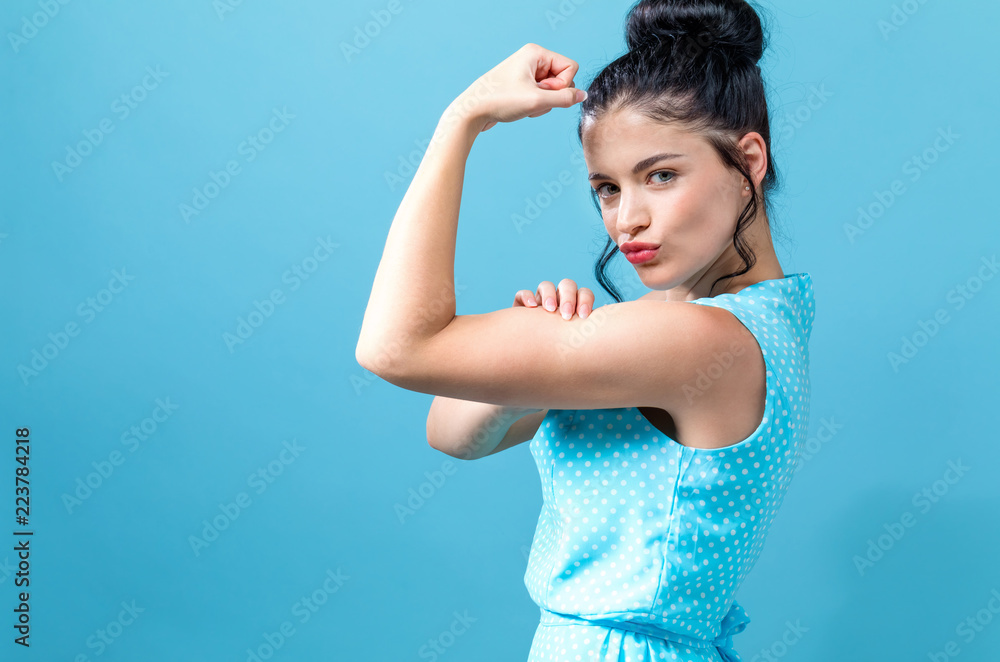 Powerful young woman in a success pose