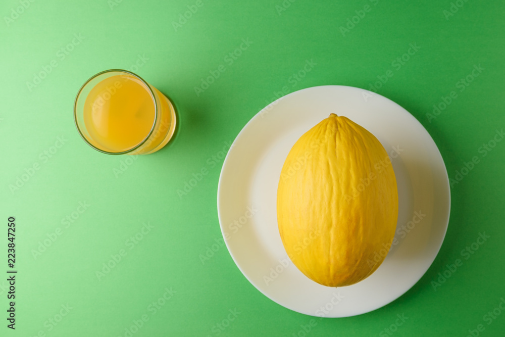 Melon on bright green background. Minimal fruit concept.