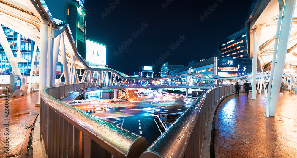 Traffic and people moving through Osaka, Japan at night