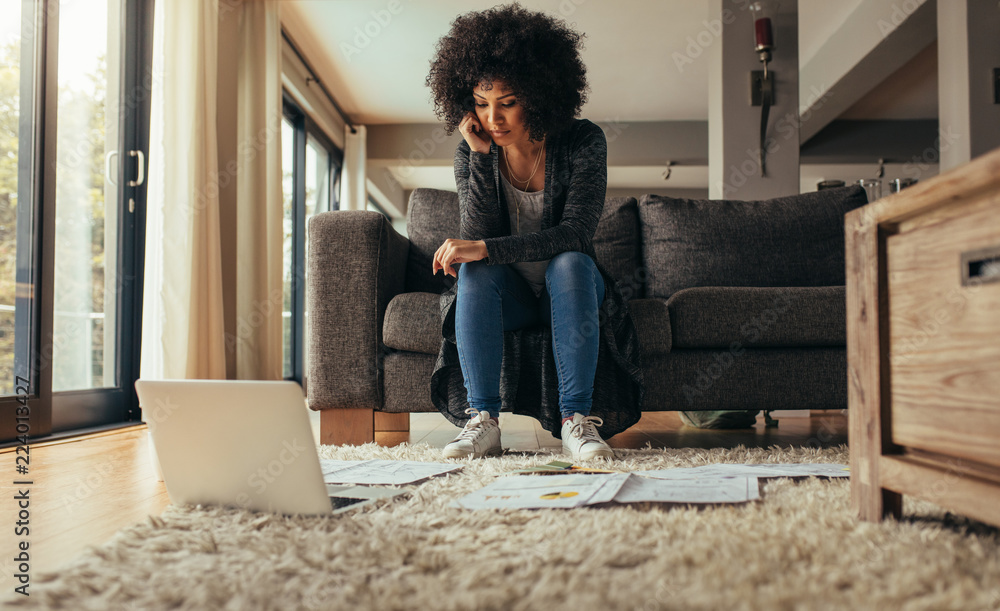 Woman at home studying business papers