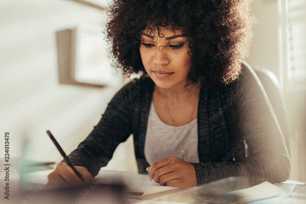 Female architect busy working at her desk