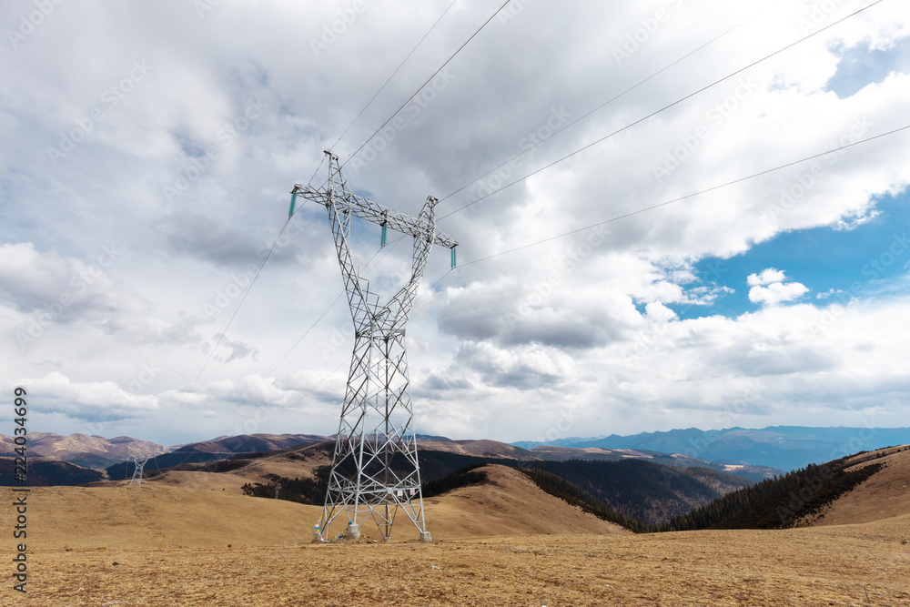 High voltage transmission tower or power tower (electricity pylon) and electrical distribution subst