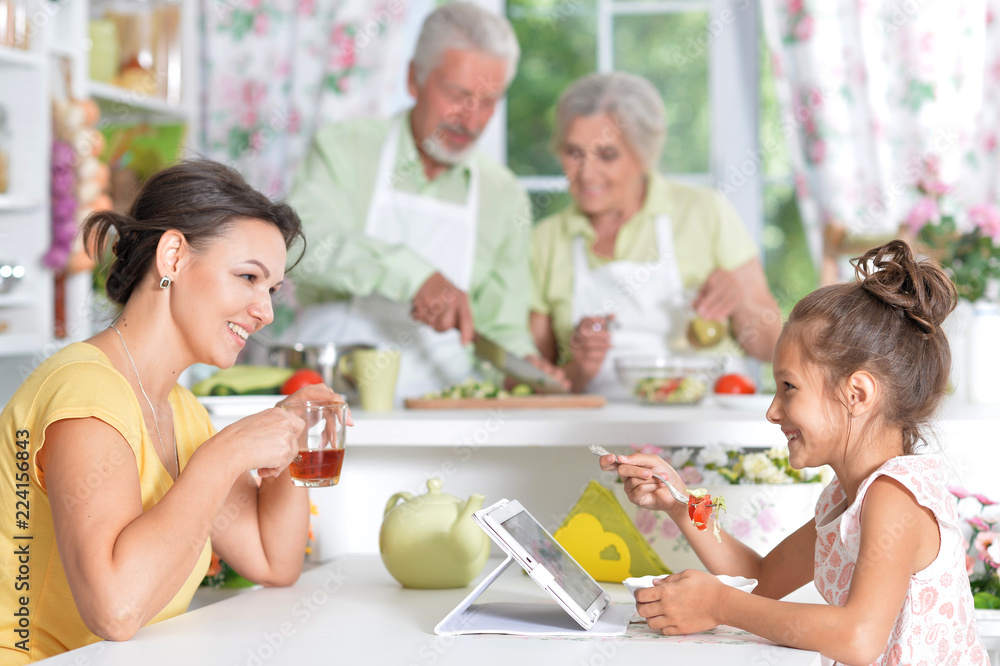 Portrait of mother and daughter having breakfast