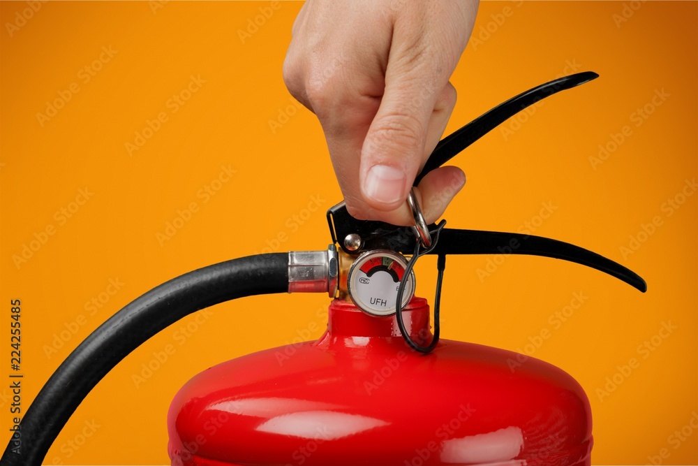 Hand presses the trigger fire extinguisher hand