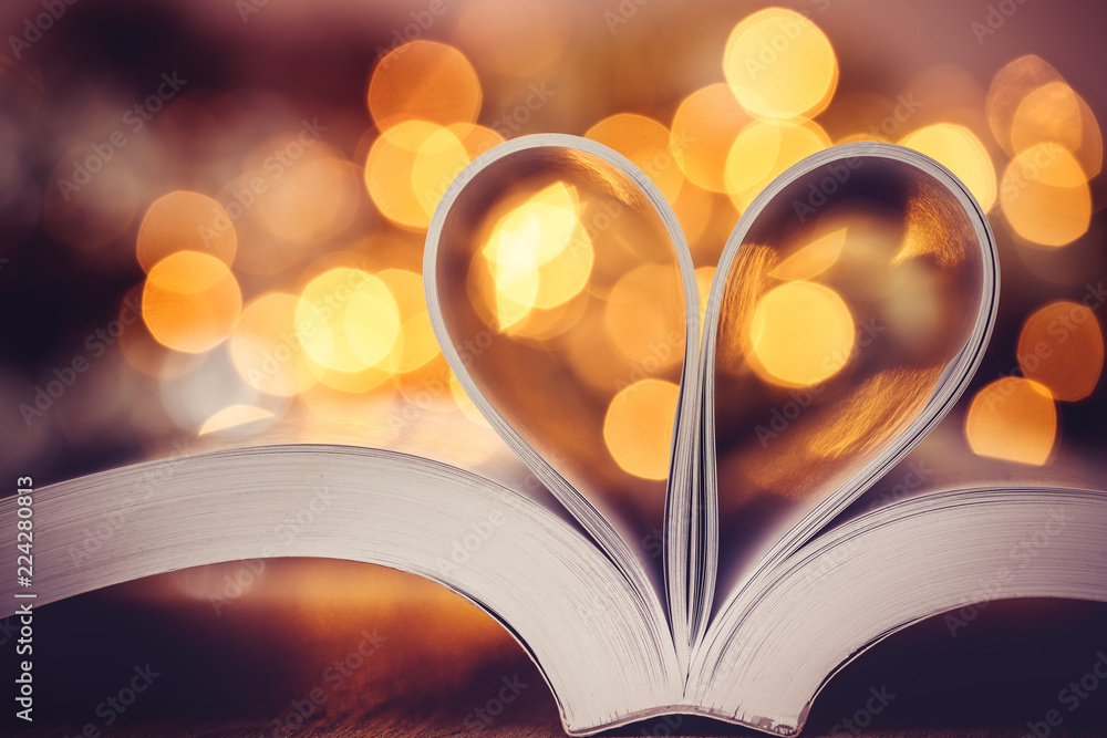 the Book page decorate to heart shape with celebration bokeh light for love and romance of valentine