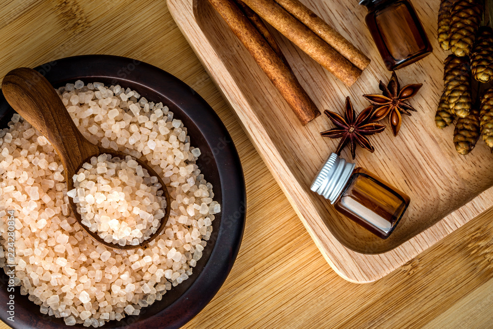 Close up brown organic Himalayan rock salt spa and cinnamon essential oil aroma set on  table , heal