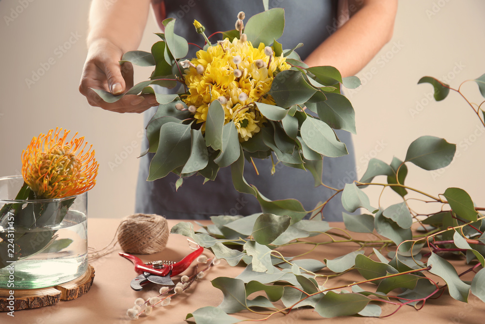 女花艺师用菊花和桉树制作美丽的花束