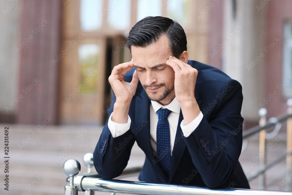 Handsome stressed businessman outdoors