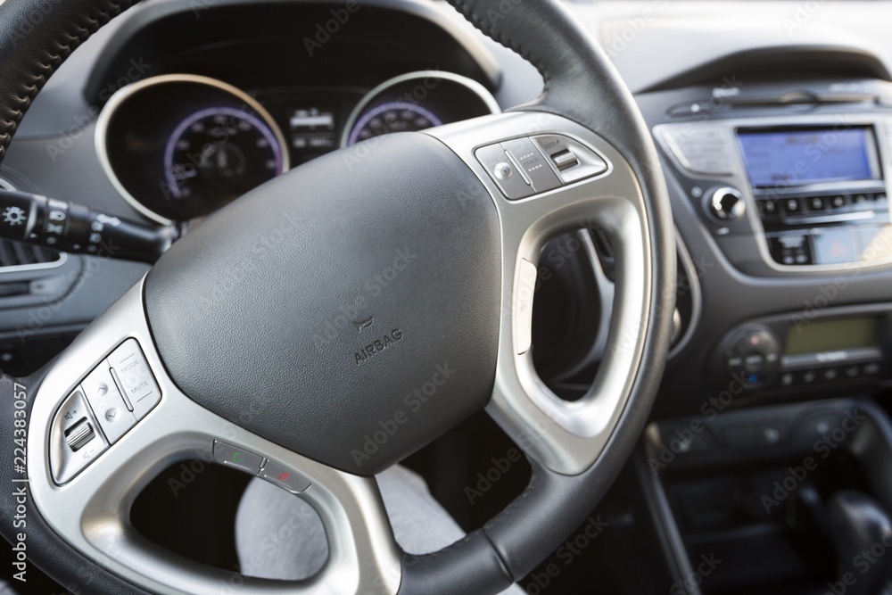 Closeup of Steering Wheel and Car Audio System in Modern Car