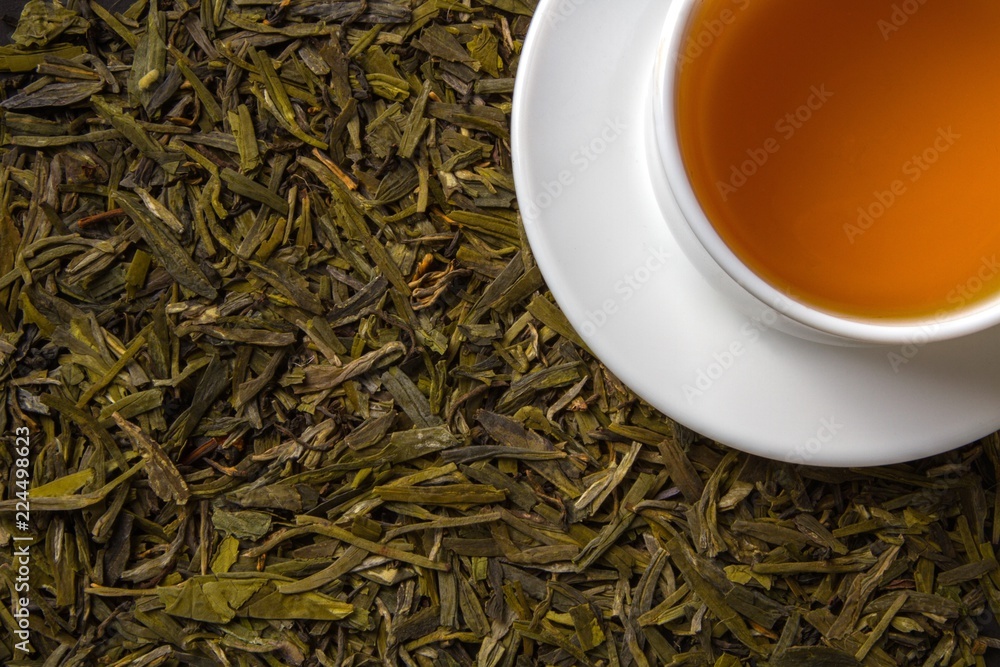 Cup of Tea on Dried Green Tea Leaves