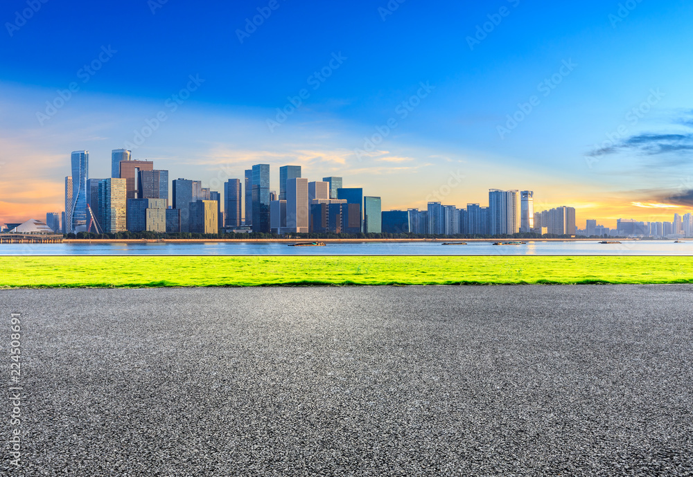 Urban asphalt road and modern buildings in Hangzhou at sunrise