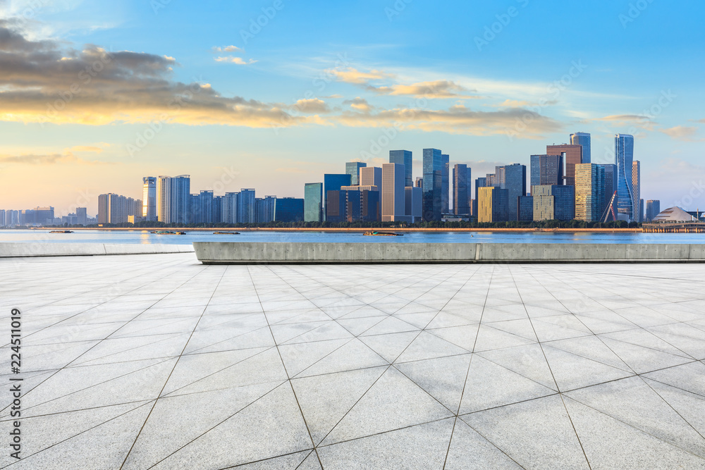 City square floor and modern buildings in hangzhou at sunrise