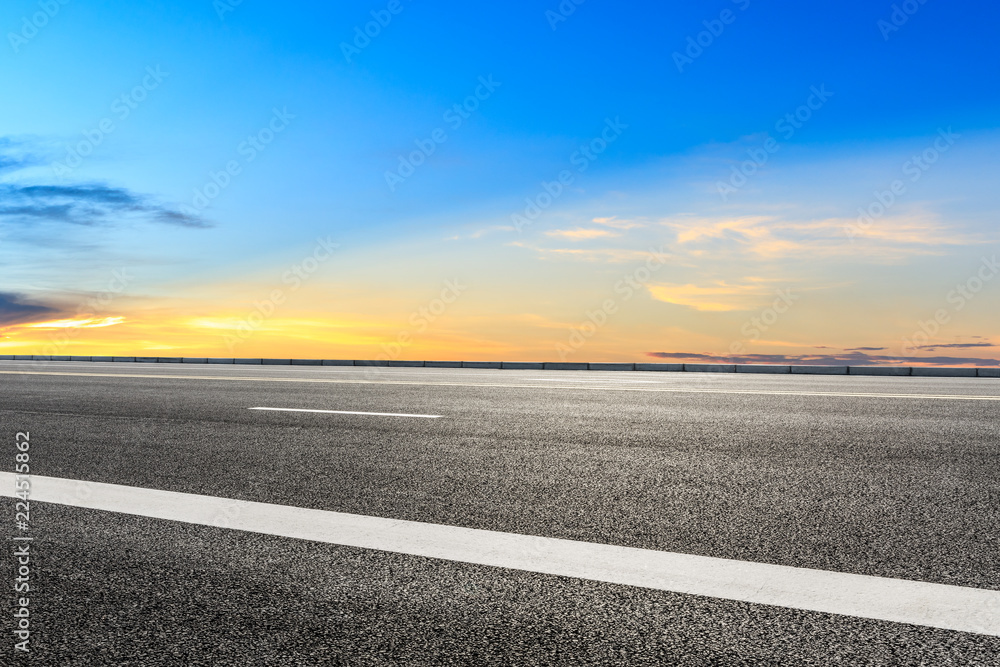 Clean asphalt highway and beautiful sky clouds at sunset