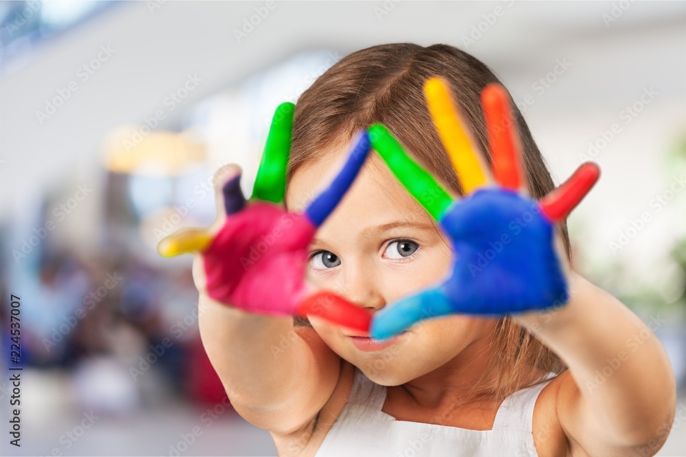 Cute little girl with colorful painted hands