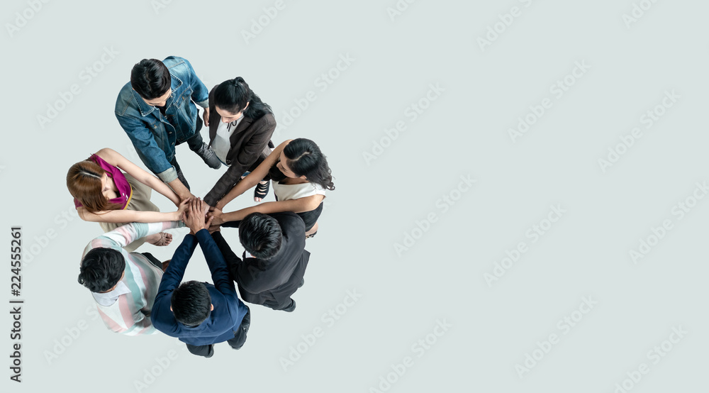 Top view of people in team stack hands together as unity and teamwork in office. young Asian team an