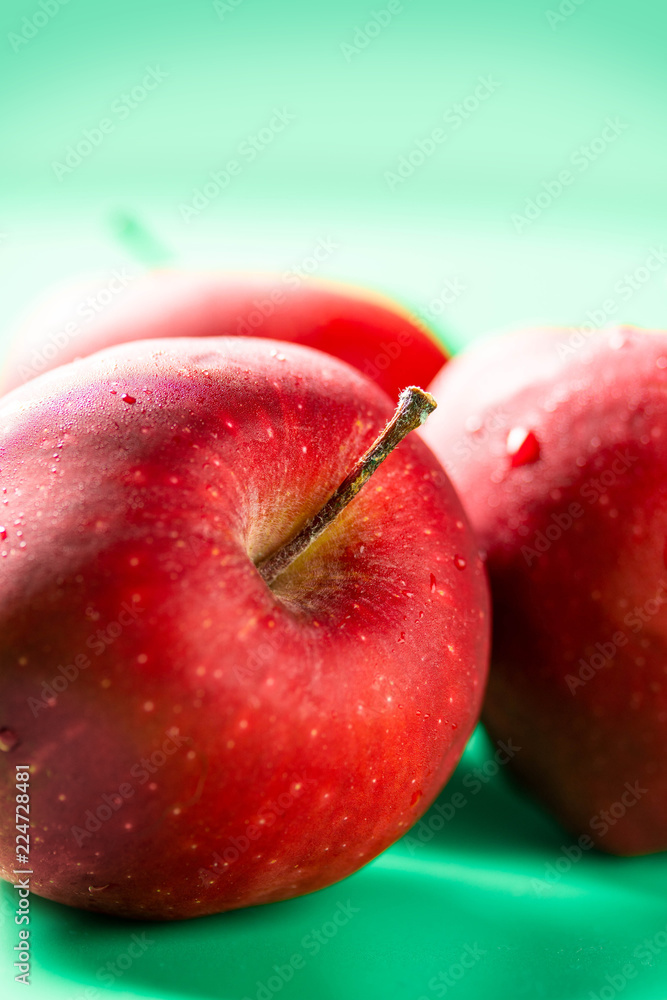 Red fresh apple group on green background