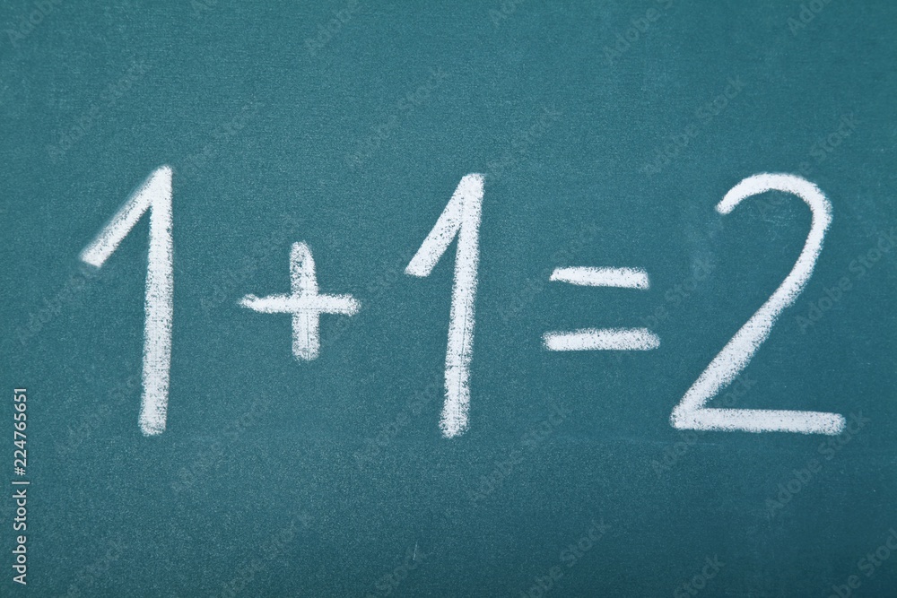 Basic arithmetic equation written on a chalkboard - 1 + 1 = 2