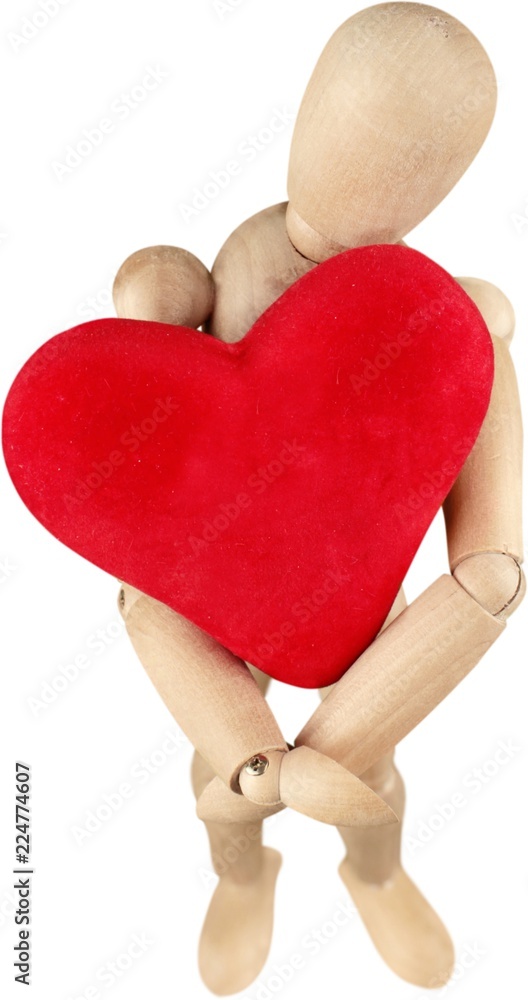 Wooden mannequin holding a heart