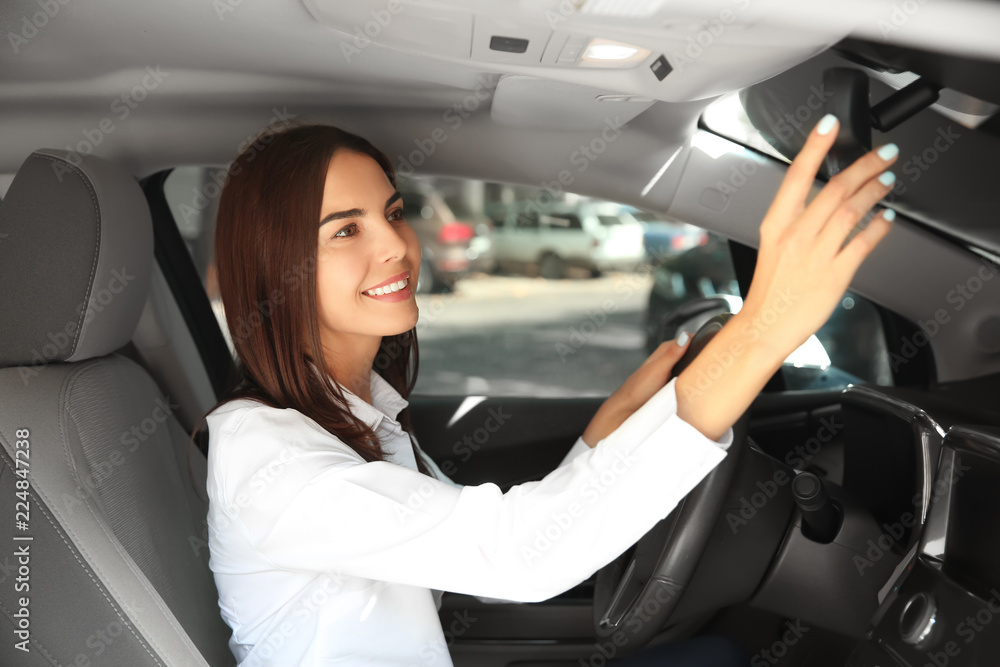 Young woman on drivers seat of car