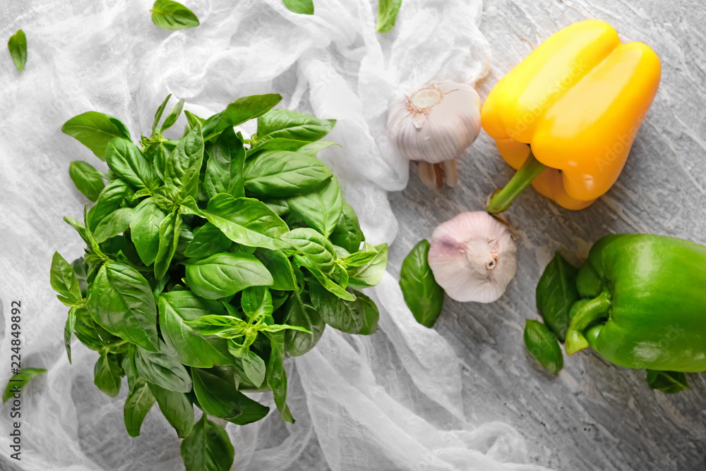 Fresh green basil with vegetables on table