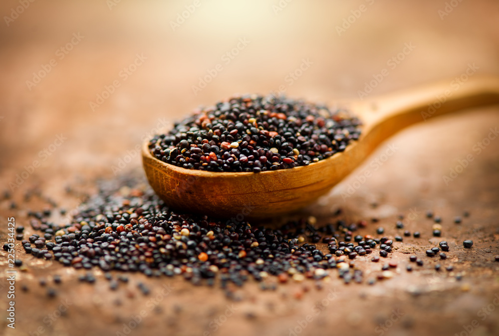 Quinoa. Black grains in a wooden spoon. Gluten free healthy food. Dieting concept. Seeds of Black qu