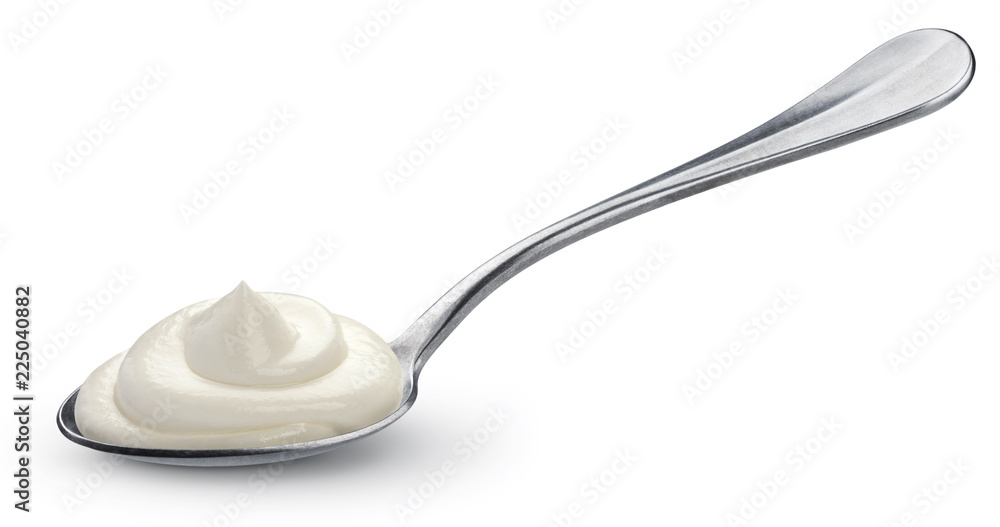 Sour cream in spoon isolated on white background