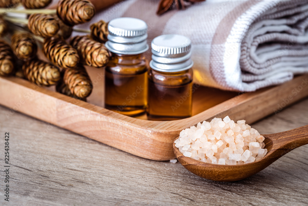 Close up brown organic Himalayan rock salt spa and cinnamon essential oil aroma set on  table , heal