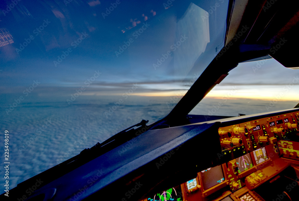 The view from commercial airplane, seen from captain seat in cockpit in the evening twilight during 