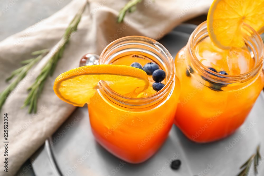 Mason jars with delicious summer cocktails on table