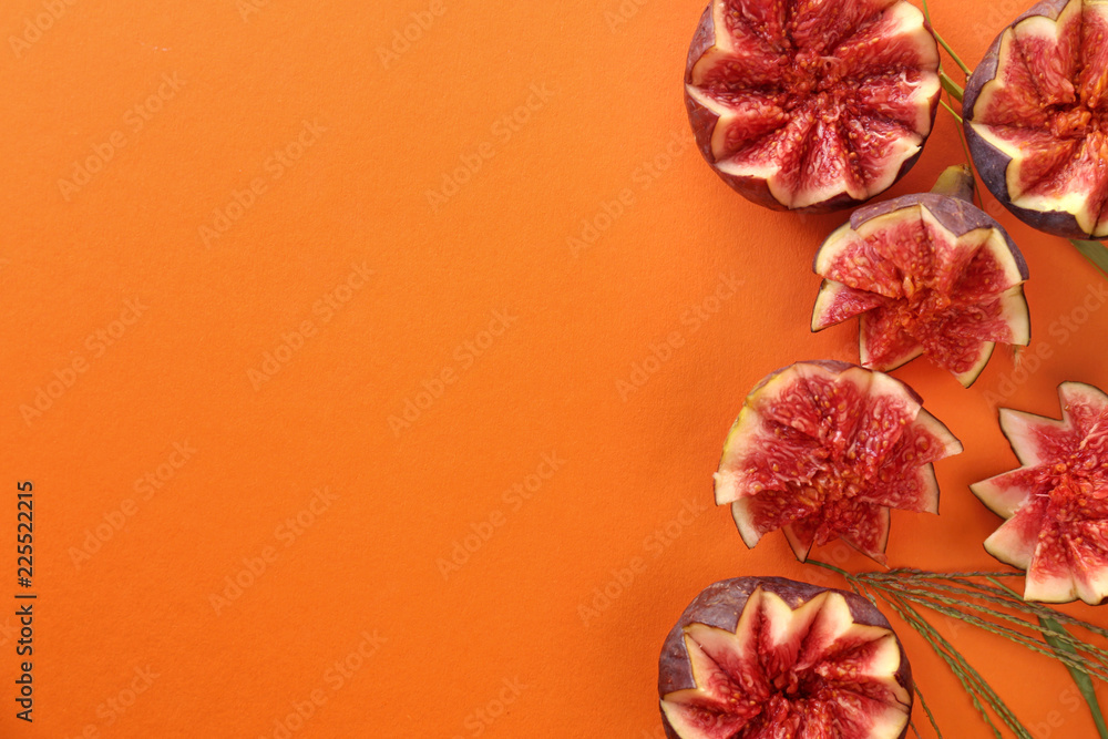 Flat lay composition with fresh ripe purple figs on color background