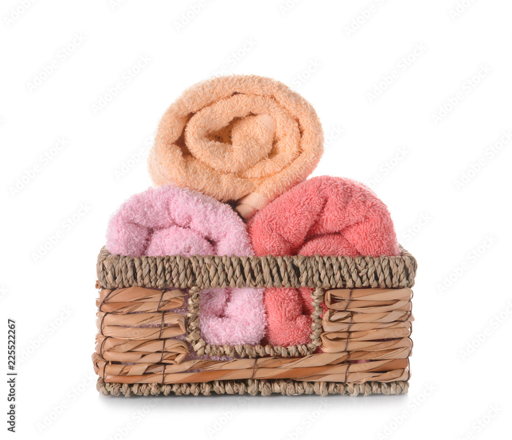 Wicker basket with clean soft towels on white background