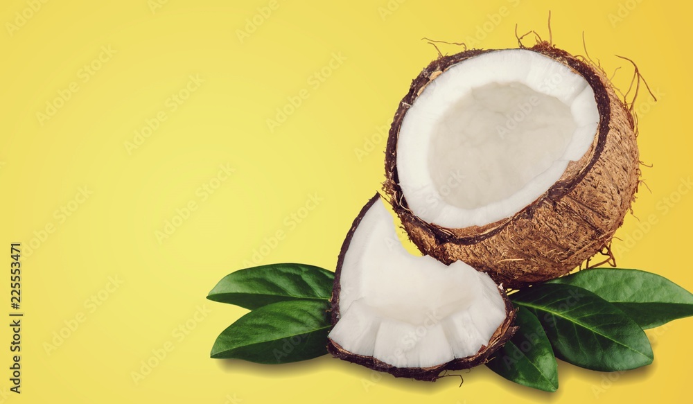 Ripe cut coconut composition on beach